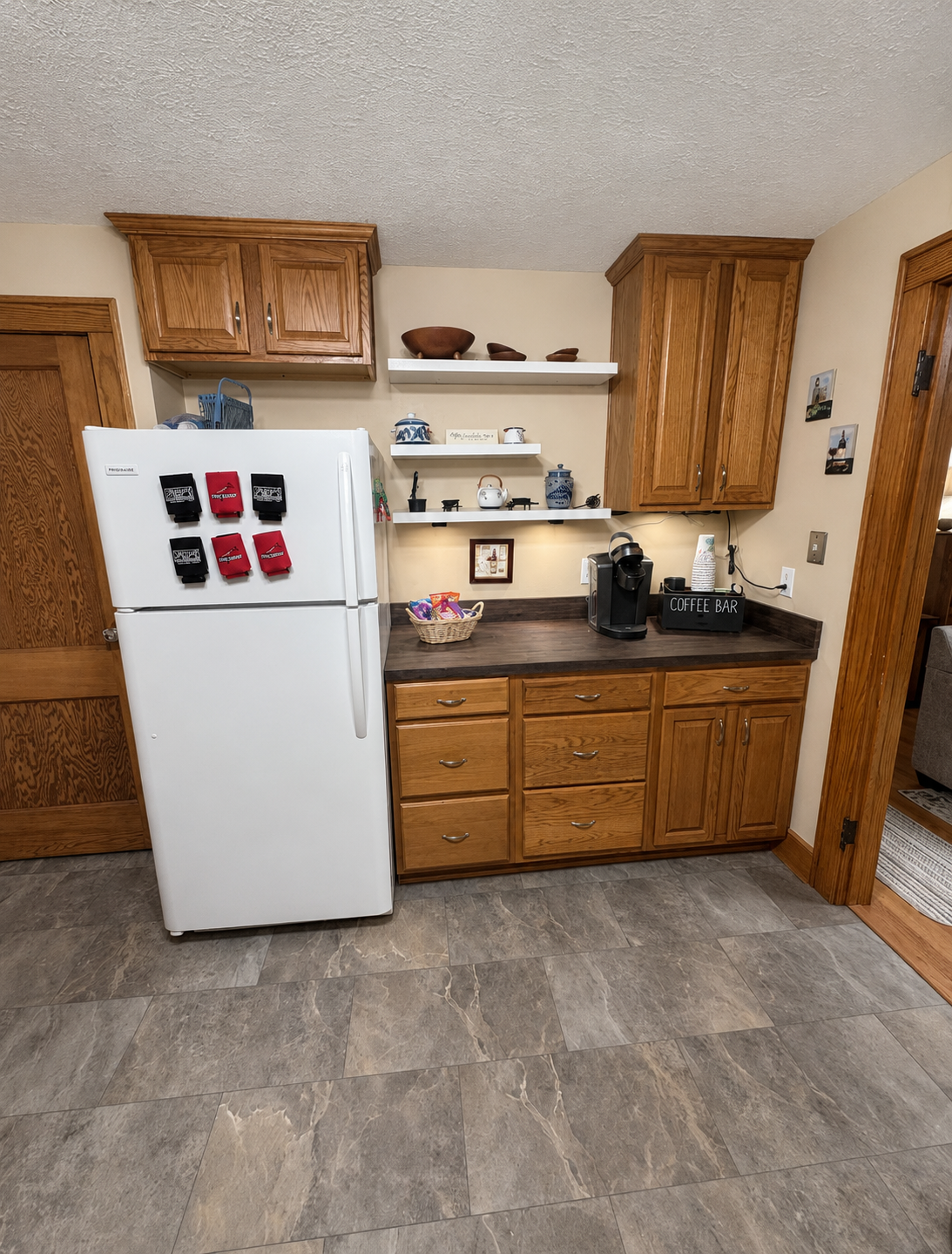 Coffee-bar area with a refrigerator, single-serve coffee maker and open shelves